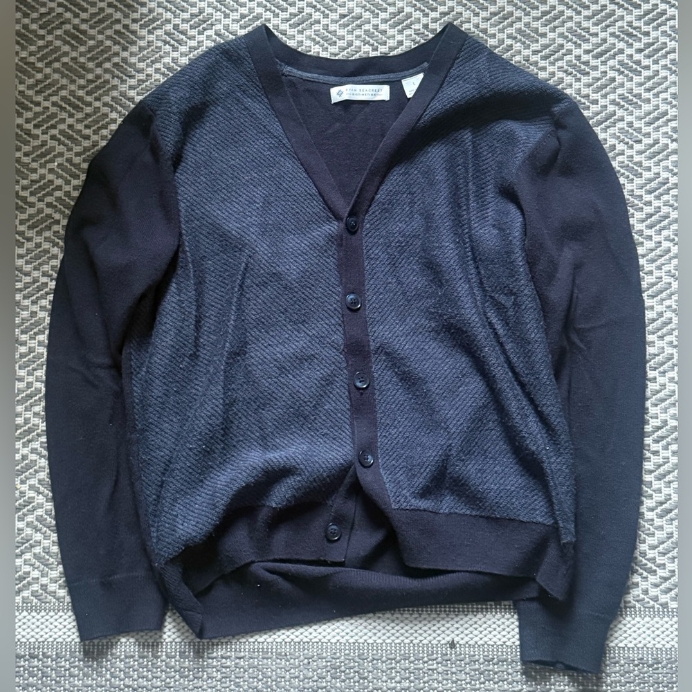 Navy blue cardigan with button-up front, featuring a relaxed fit